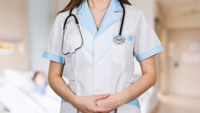 woman in white button up shirt and blue stethoscope