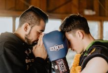 two men praying inside room