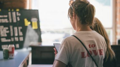 woman in white t-shirt looking at the window during daytime