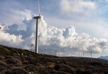 white wind vanes under cloudy sky during daytime