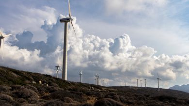white wind vanes under cloudy sky during daytime
