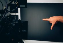 person lying on bed near black flat screen tv