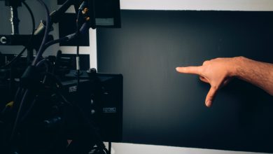 person lying on bed near black flat screen tv