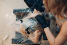 woman in black shirt lying on white textile