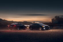 black sedan on parking lot during sunset