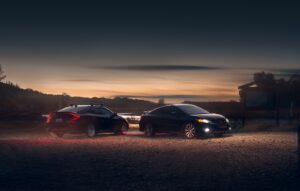 black sedan on parking lot during sunset