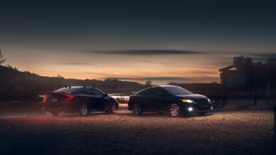 black sedan on parking lot during sunset