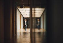 man walking towards opened door
