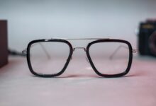 black framed eyeglasses on white surface