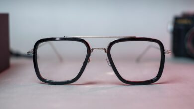 black framed eyeglasses on white surface