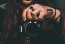 man holding DSLR camera