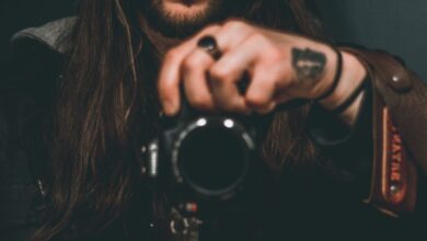 man holding DSLR camera