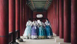man and woman in white and blue dress walking on hallway
