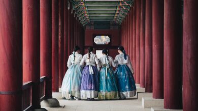 man and woman in white and blue dress walking on hallway