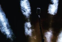 a microphone on a stage with smoke coming out of it