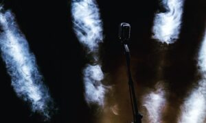 a microphone on a stage with smoke coming out of it