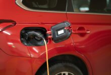 red car with yellow hose