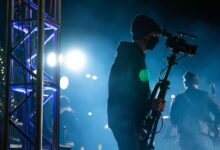 man in black jacket holding black microphone