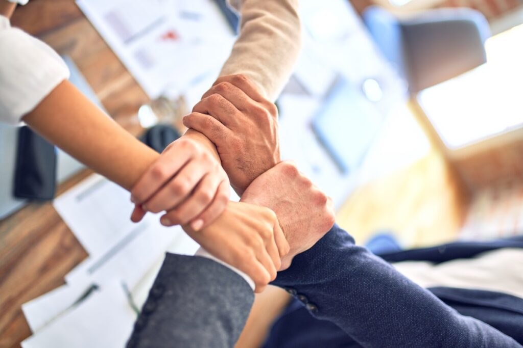 person in black long sleeve shirt holding persons hand
