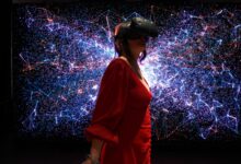 a woman in a red dress wearing a virtual reality headset