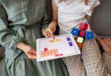 child playing game on white ipad