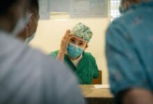 woman in green hijab holding man in blue dress shirt