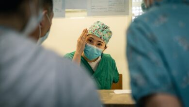 woman in green hijab holding man in blue dress shirt