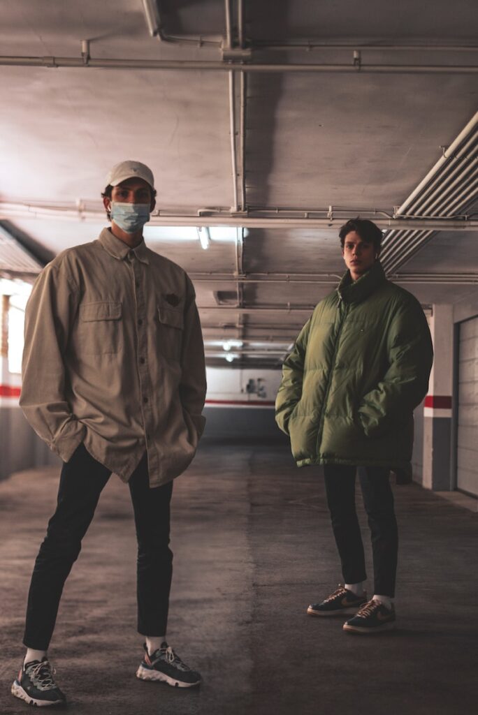 man in green jacket standing beside man in green jacket