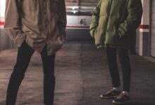 man in green jacket standing beside man in green jacket