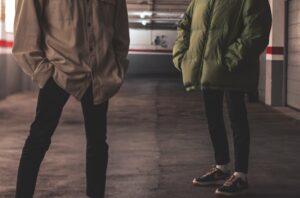 man in green jacket standing beside man in green jacket
