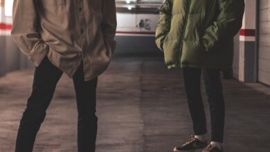 man in green jacket standing beside man in green jacket