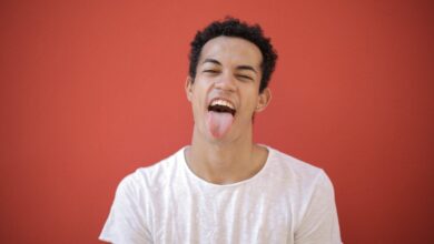 Man in White Crew Neck T-shirt Sticking his Tongue out