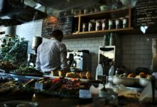 man standing beside espresso maker