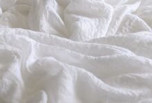 white textile on brown wooden table