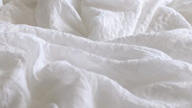 white textile on brown wooden table