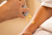 a woman getting her nails done at a nail salon