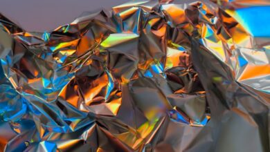 a close up of a shiny surface with a blue sky in the background