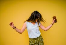 woman standing near yellow wall
