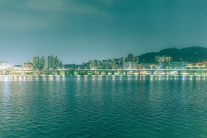a large body of water with a city in the background