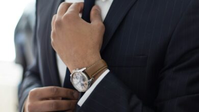 man wearing watch with black suit