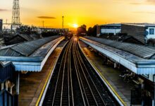 photo of brown train track at sunset