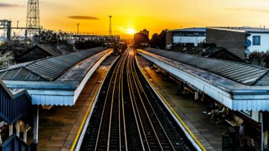 photo of brown train track at sunset