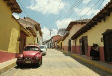 a red car parked on the side of a road