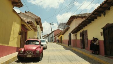a red car parked on the side of a road