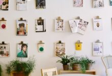 magazines hanged on wall near round beige wooden table