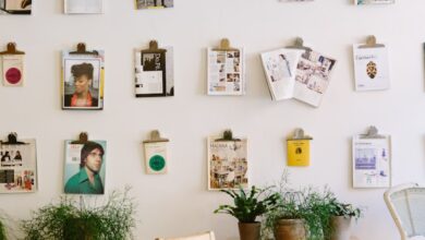 magazines hanged on wall near round beige wooden table