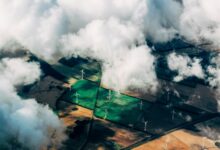 aerial photo of wind turbines near field