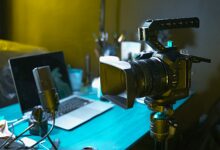 a laptop computer sitting on top of a wooden desk