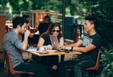 photo of three person sitting and talking