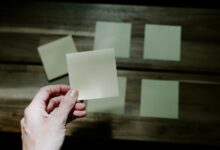 a hand holding a piece of paper